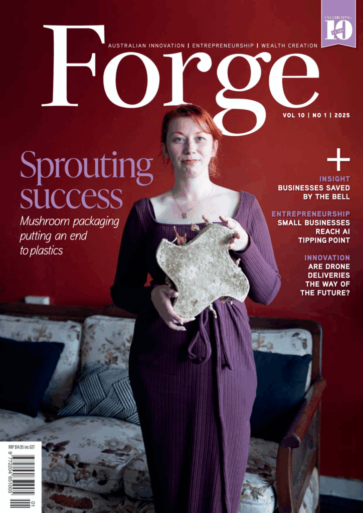 Front Page Feature Cover of Forge Magazine, showing CEO and Founder holding some of the mushroom materials with red backdrop.